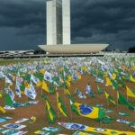 Cena de manifestação em Brasília com Congresso Nacional e raio no céu tempestuoso, representando visita a vítimas.