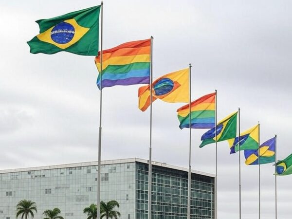 Edifício da CLDF em Brasília com bandeiras LGBTQIAPN+ em dia nublado, representando anúncio do Programa Reconhecer amid críticas.