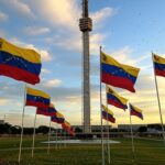 Torre de TV em Brasília com bandeiras venezuelanas e confetes, representando comemoração de exilados pela prisão de Maduro.