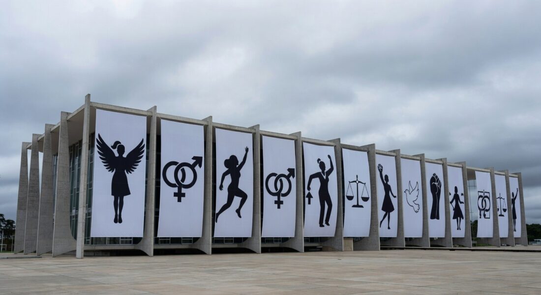 Edifício da CLDF com banners da Semana da Mulher, destacando críticas por falta de ações contra desigualdades.
