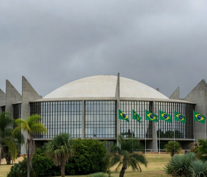 Fachada da Câmara Legislativa do DF em Brasília, com céu nublado, representando críticas à Procuradoria da Mulher.