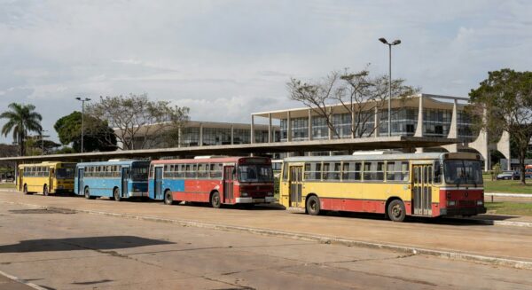 Estação de ônibus no DF com veículos desgastados representando falhas no transporte público
